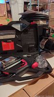 Overview of air compressor alongside nailer case and accessories