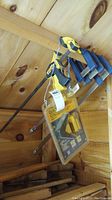 Four yellow and black Quick-Grip clamps hanging on wall, including one long 30-inch clamp and three smaller Mastercraft clamps.