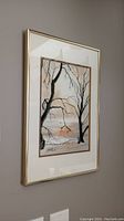 Framed watercolour painting showing the full artwork with visible winter landscape scene and some damage to the frame glass.