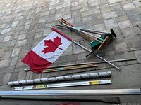 Full layout of lot including flag with pole, brooms, squeegee, folding triangle in storage tube, yardsticks, and pry bar.