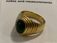 Front view of ring showing green jade cabochon and stepped bezel