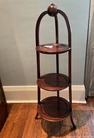 Front view of the 3 tier antique wooden tea stand showing the full height and three round tiers with polished dark wood finish.