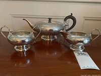 Three-piece tea set on wooden surface
