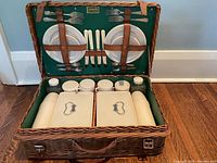 Open wicker picnic basket showing entire contents and interior arrangement