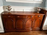 Full front view of the walnut buffet against wall