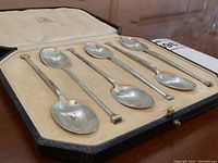 Six teaspoons displayed in original fitted case with velvet bed and satin lid lining