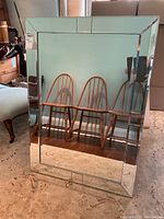 Front view of large rectangular beveled mirror showing clean reflective surface and geometric beveled border.