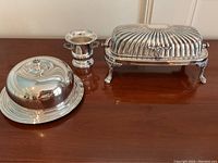 Photo showing all three items: rectangular butter dish, round butter dish, and covered vegetable server.