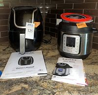 PowerXL Vortex Air Fryer on left and Instant Pot Duo Nova Mini on right with owner's manuals in front.