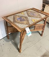 Angle view of the full folding table with tray on top, showing wooden frame and carved details.