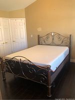 Full view of queen bed frame and mattress in bedroom