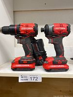 Side-by-side photo showing Craftsman cordless drill driver and impact driver with batteries and charger.