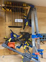 Overview on wooden workbench showing a mix of Irwin Quick-Grip clamps, Wolfcraft aluminum bars, Western Rugged F-clamps and one Wolfcraft 90° corner clamp