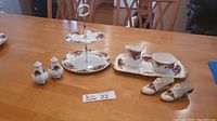 Full set displayed together showing Royal Albert Old Country Rose serving accessories including the 2-tier cake plate, salt and pepper shakers, shoe toothpick holders, cream and sugar with service plate
