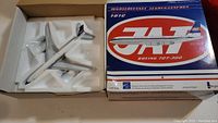 Boeing 707-300 model airplane in original molded styrofoam tray inside original box with blue and red lid and JAT logo.