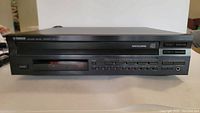 Front view of Yamaha CDC-675 CD changer showing controls, display, and headphone jack.