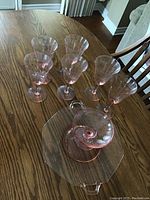 All six wine glasses and serving platter on wood table