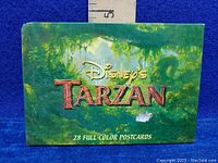 Front of the postcard box showing Disney's Tarzan title and indication of 28 full-color postcards inside.