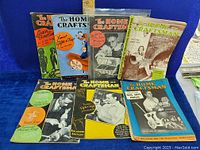 Photo of eight vintage The Home Craftsman magazines arranged in two rows showing colorful and black-and-white illustrated covers from the 1930s and 40s featuring various woodworking and home craft projects.