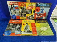 Seven vintage Home Craftsman magazines arranged in two rows showing covers with different themes and colors, including craft projects and games.