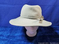 Front view of the vintage gray furfelt hat showing indented crown, wide brim and folded bow on band.