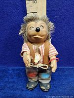 Full front view of the Mecki Hedgehog Man Doll standing in front of a ruler showing height and detailed clothing.