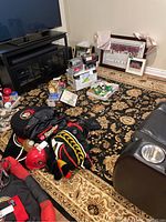 Full view of the floral area carpet under furniture and other items; black background with beige and brown floral pattern.