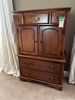 Front view of Vilas dresser with three drawers and two-door cabinet on top.
