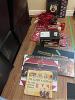 Photo of the full collection on a dining table showing various Ottawa Senators memorabilia: books, pom-poms, drinkware, toaster box, framed jersey.