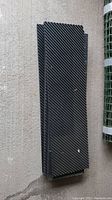 Stacked view of black rubber outdoor step mats showing ridged texture and edges.
