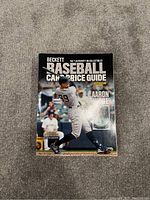 Photo of Beckett Baseball Card Price Guide 45th Edition 2022 featuring Aaron Judge on the front cover, showing the book in good condition on a carpeted floor.