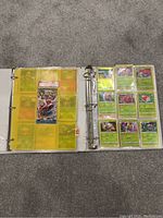 Open binder with front and back plastic sleeves visible showing multiple Pokémon cards
