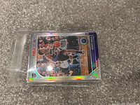 Photo showing a close-up of a basketball trading card featuring Rudy Gobert from the NBA Hoops series with holographic finish.