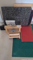 Full view of the printmaking press, papers, cutting mat and carry bag