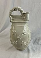 Vase front view showing applied motifs and twisted handle