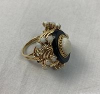 Ring displayed on grey cloth, three-quarter view