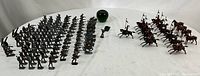 Overall view of lot showing infantry, cavalry and green glass apple for scale