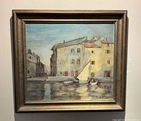 Front view of framed oil painting depicting Venetian canal scene, signature visible lower right.