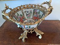 Full front view of porcelain bowl mounted on gilt bronze stand