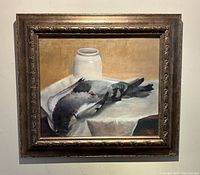 Full front view of the framed still life painting showing two birds on white cloth and a jar on the table.
