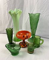 Photo showing all seven glass pieces grouped together with visible sizes, colors, shapes, and details.