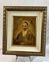 Front view of oil on board portrait in carved gilt frame with linen slip