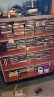 Wide view of shelves filled with stacks of music CDs in jewel cases