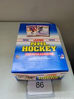 Photo of unopened blue box of 1990 Score NHL Hockey Premier Edition hockey card packs from front angle