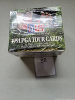 Front view of the unopened sealed 1991 PGA Pro Set golf card box showing branding and packaging details.