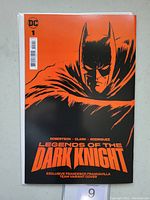 Front cover of Legends of the Dark Knight #1 comic book in orange and black featuring Batman silhouette and title.