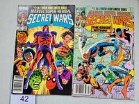 Front covers of two Marvel Super Heroes Secret Wars comic books, issues #2 and #3, showing their detailed illustrations and condition.