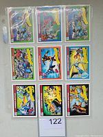 Front side of nine 1990 Impel Marvel trading cards held in plastic sleeves, showing famous battles including Hulk vs Spider-Man and Wolverine vs Sabretooth.