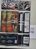 Front view of three sealed rack packs of 1994 Topps Stadium Club Basketball cards showing foil packaging and NBA logos.
