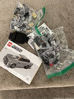 LEGO Speed Champions set pieces in multiple bags and manual featuring a gray vintage convertible car model.